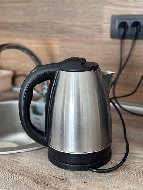istock A stainless steel electric kettle placed on a wooden kitchen countertop. Modern kitchen appliance blends well with rustic wooden finishes 2203656896