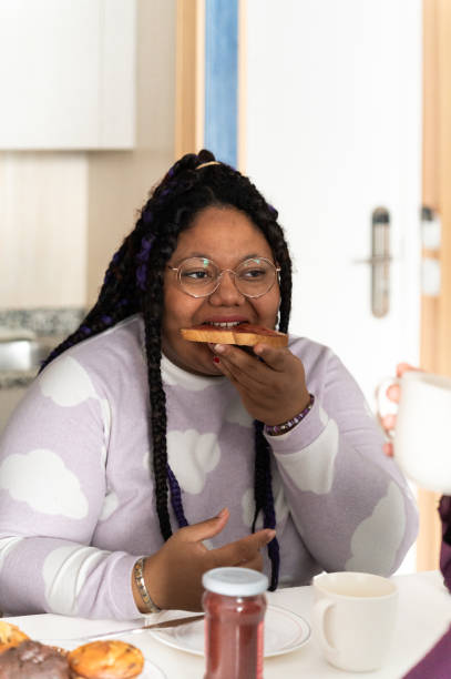 istock Woman enjoying a toast with jam at breakfast table 2203659225
