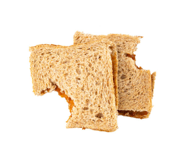 Bitten dried pate sandwich isolated, low-quality food leftovers, bad quality toast bread lunch Bitten dried pate sandwich isolated, low-quality food leftovers, bad quality old toast bread, taste bad peanut butter lunch on white background top view terrible meal stock pictures, royalty-free photos & images