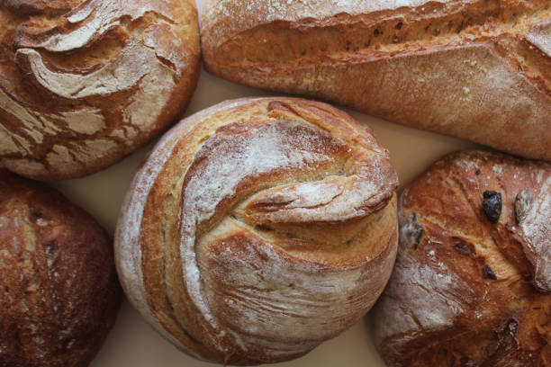istock Bread. Assortment of different types of bread on a background. Loaf, bun, baguette, cereal bread. Bakery products 2203667373