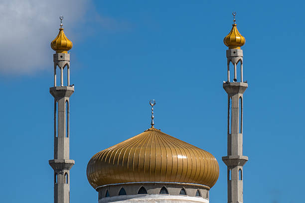istock The mosque's golden crown, a breathtaking sight against the cerulean backdrop. 2203667774