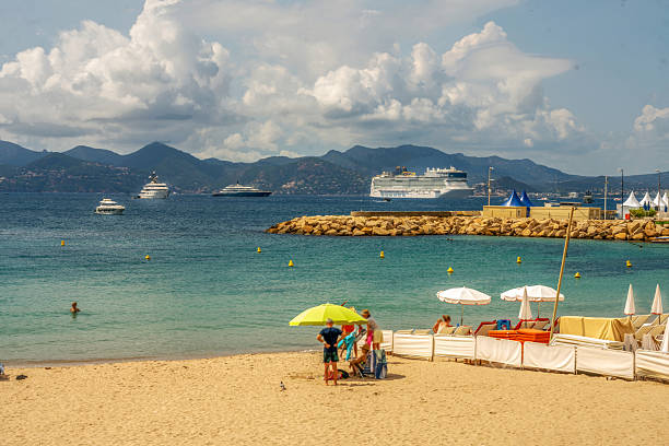 istock Blurred motion people on beach and bay of Cannes 2203669597