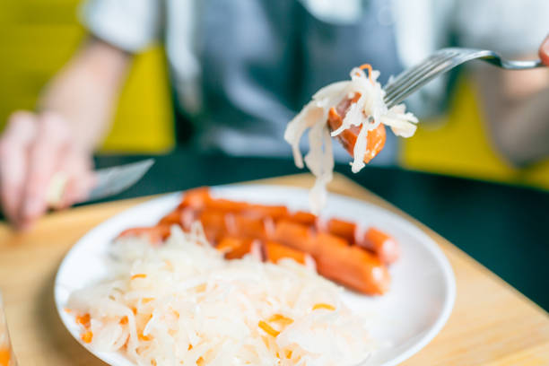 Sauerkraut and sausage on a fork, close-up view of a classic German dish