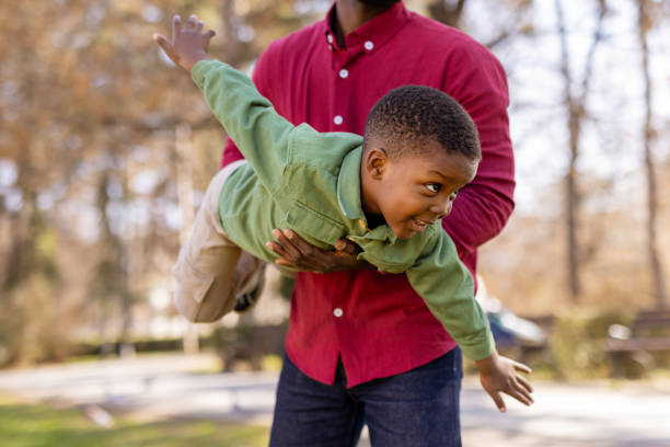 istock Happy African American Dad and Son Having Fun Outside 2203672576