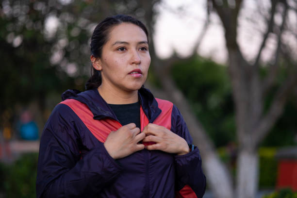 Portrait of a female runner adjusting her jacket to begin her morning running routine