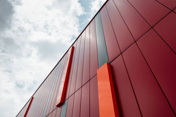 istock Looking up at the red building wall and clear blue sky in the background. 2203674097