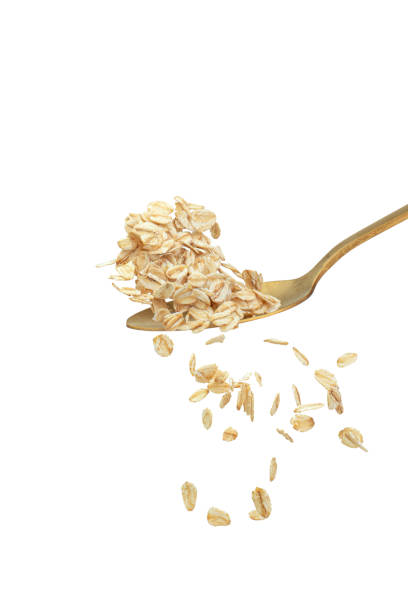 istock Oat flakes falling into a golden spoon 2203675444