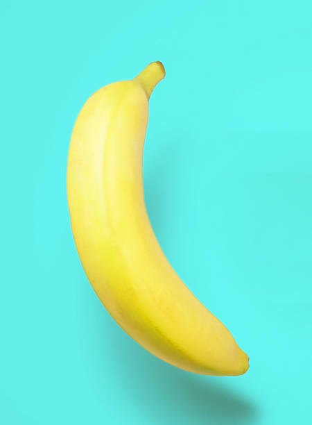 istock banana isolated on turquoise background 2203676773