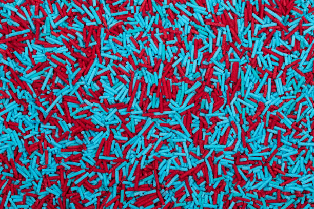 istock Vibrant Red and Turquoise Blue Sprinkles Background - Colorful Jimmies Texture for Baking Decorations, Confectionery Toppings, and Modern Dessert Garnishes 2203676987