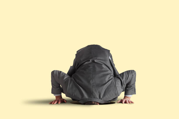 istock Businessman With His Head In A Hole 2203677439