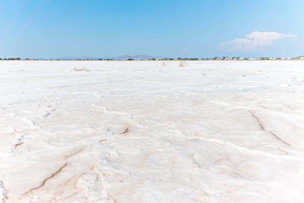 Tigaki salt lake or pan, chrisp white against blue distant sky in Kos Island.