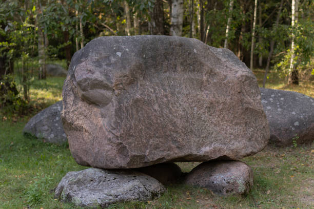 istock A cluster of huge boulders in a sunlit clearing. 2203678517