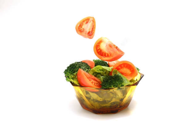 Fresh vegetable salad in a glass crockery isolated on a white background.
