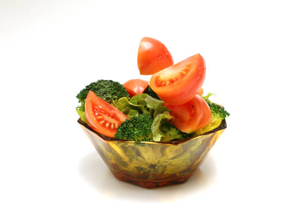 Fresh vegetable salad in a glass crockery isolated on a white background.