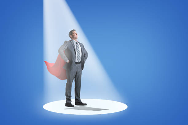 silhouette of super businessman with cape back to you in the sunset