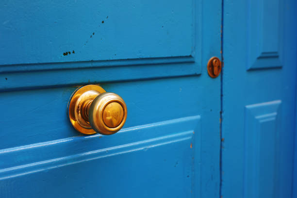 wooden blue door and gold handle