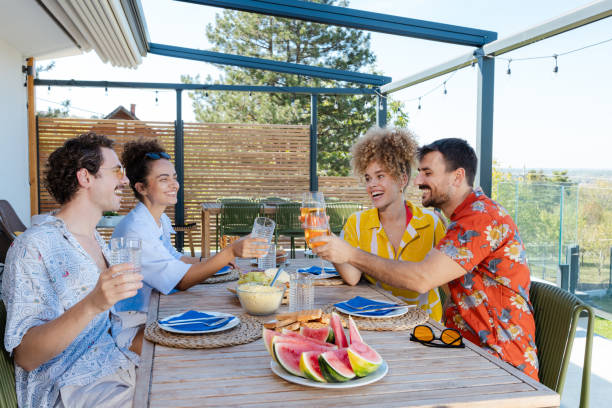 istock Friends enjoying a summer outdoors on a house balcony 2203681372