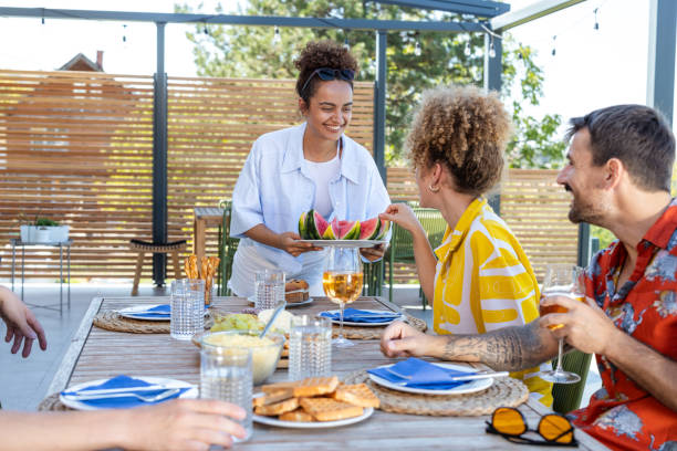 istock Friends gather for summer dining on a modern outdoor terrace 2203681477