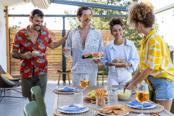 istock Friends celebrating with drinks on a sunny balcony gathering 2203681535