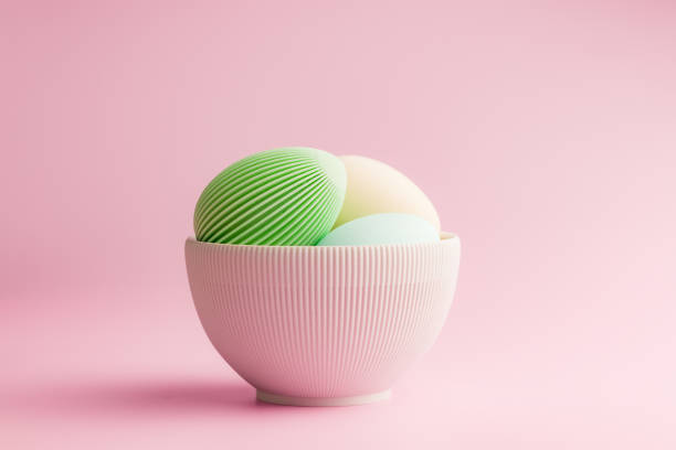 istock Easter decoration. Colorful eggs in bowl on pink background. 2203682468