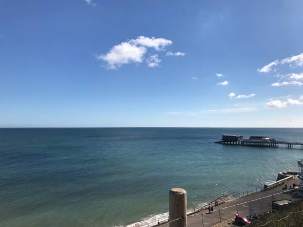 A beautiful beachside at the waters edge on an English beach, on a summers day with a slight cloudy sky, tranquil and serene with no people