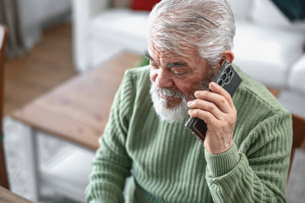 istock A pensioner sits at the dining room table and works on a laptop 2203686554