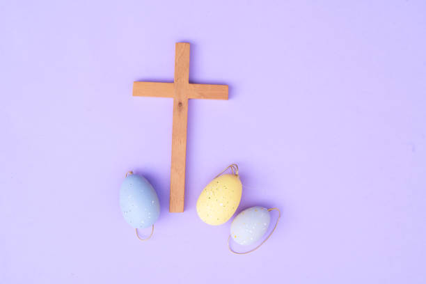 Wooden cross with painted eggs, Christian Easter concept