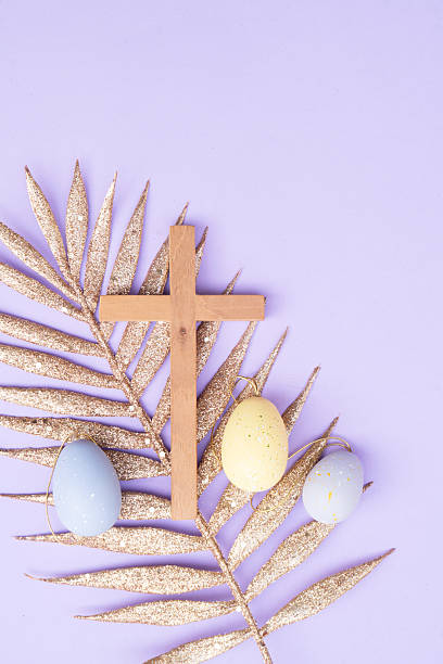 istock Wooden cross with painted eggs 2203691016