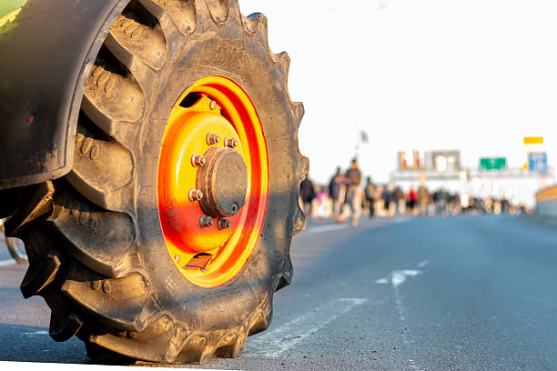 Tractor on the street. Rubber tire from the  tractor, bulldozer or other construction equipment