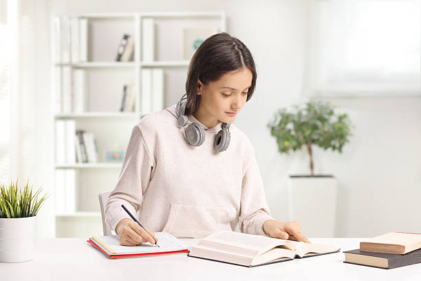 istock Teenage female student writing homework 2203697166