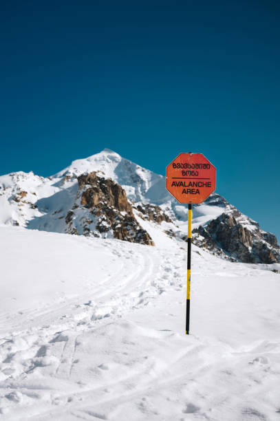 Fall warning sign from the mountain in winter. Alpine landscape.