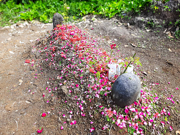 istock Traditional Indonesian Grave with Flower Offerings 2203705241