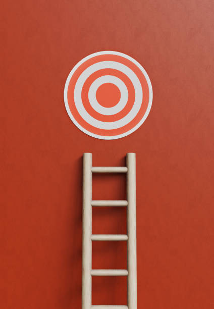 istock Ladder leads to a target on a red wall 2203705747