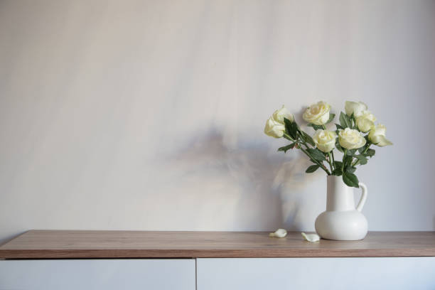 istock white roses in white jug on background gray wall 2203712024