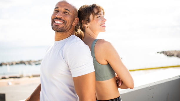 Fitness Duo Smiling Back-to-Back