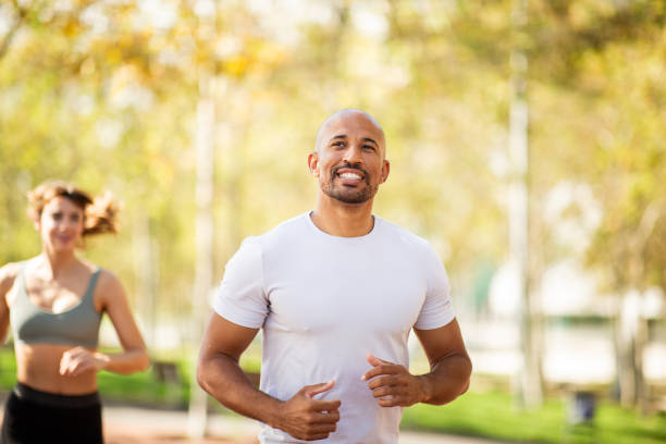 istock focused man enjoys a run in park 2203712785