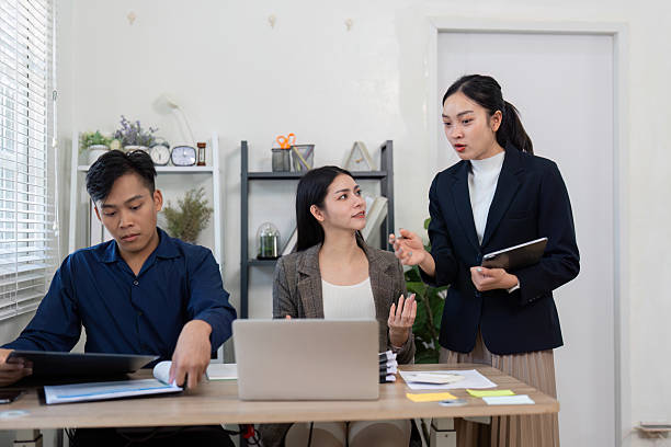 istock Team brainstorming solutions in a modern office, highlighting collaboration and communication. 2203717345