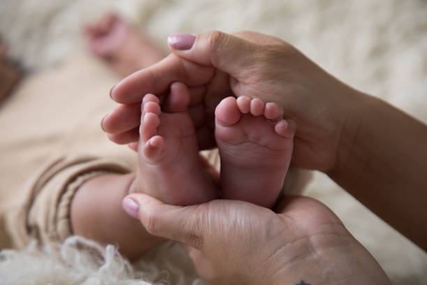 istock Newborn baby feet close up 2203722493