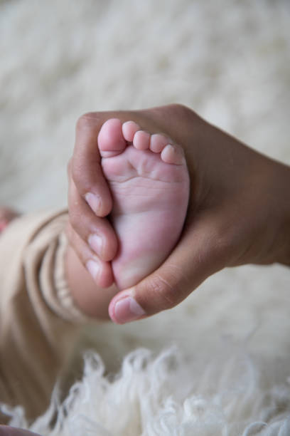 istock Newborn baby feet close up 2203722498