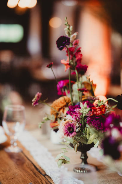 istock Brightly colored flowers in a vase centerpiece at wedding reception 2203722569