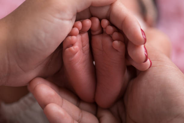 istock Newborn baby feet close up 2203722609