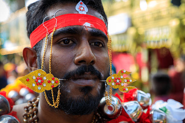 Penang, Malaysia - February 11, 2025:  A Hindu devotee with piercings during the Thaipusam celebration, a Tamil Hindu festival celebrated Tamil Hindu festival celebrated on the first full moon day of the Tamil month of Tai which is coincides during mid January to mid February.