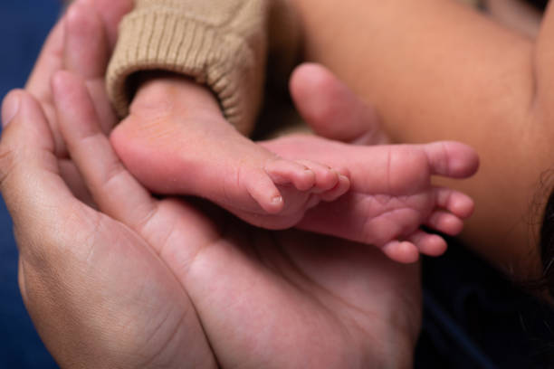 istock Newborn baby feet close up 2203724448