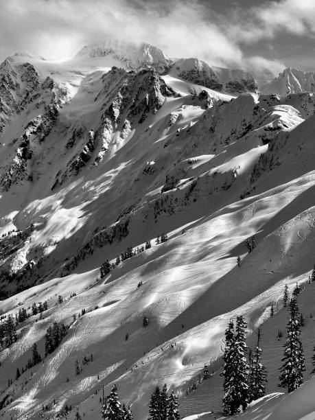 snowbound rocky mountain chain in dense mist and clouds