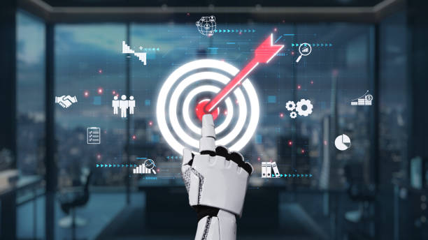 istock Futuristic robotic hand aiming at a digital target with various business icons and data analytics in a modern office setting at dusk. Auvana 2203725233
