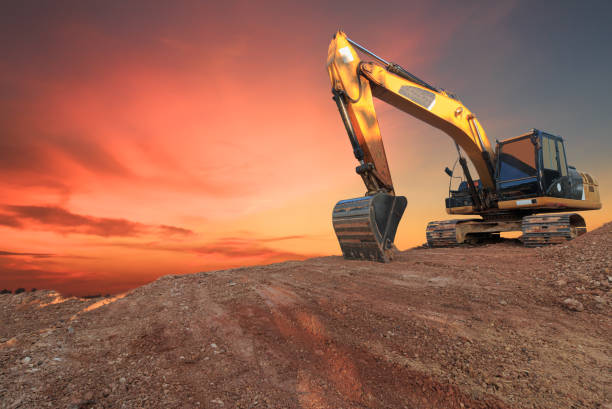 istock Yellow  Excavators are digging the soil in the construction site . 2203725315