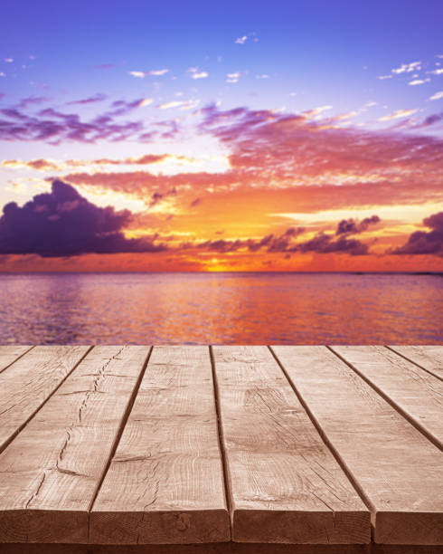 istock Empty wooden table top with tropical ocean sunset background 2203727579