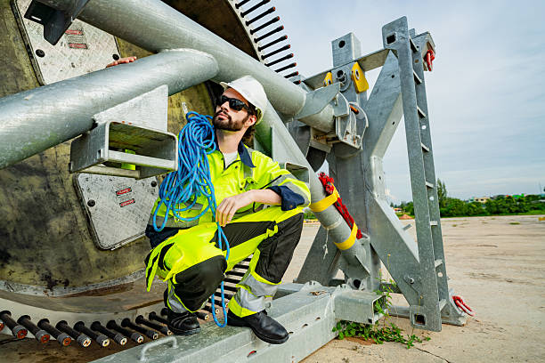 istock Brightly dressed worker poses beside heavy machinery at a construction site during the day 2203729429