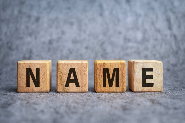 istock name word text on wooden block on grey background 2203732081
