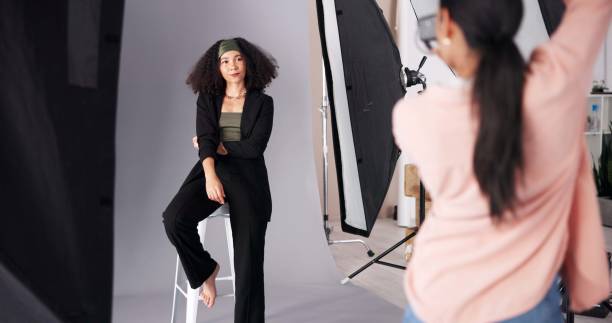 istock People, model or camera for photoshoot on set, collaboration and instructions for shooting. Women, female photographer and pictures for fashion magazine, aesthetic image and media agency backstage 2203733709